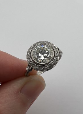 Lot 145 - A diamond cluster ring, the transitional round...