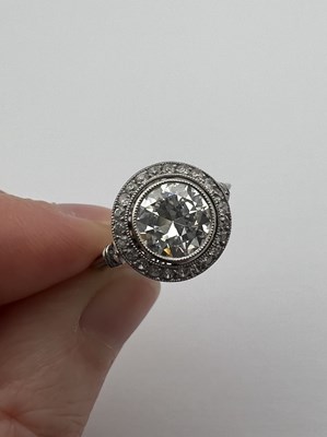Lot 145 - A diamond cluster ring, the transitional round...