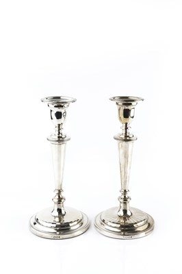 Lot 480 - A pair of silver candlesticks, with reeded...