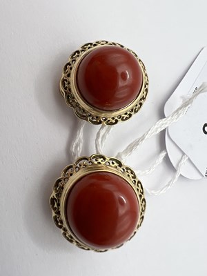 Lot 85 - A pair of coral ear clips, each coral...