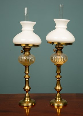 Lot 52 - A pair of brass oil lamps with glass shades,...