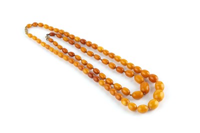 Lot 31 - Two amber bead necklaces, the first comprising...