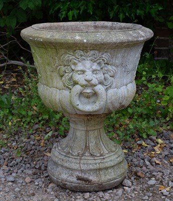 Lot 695 - A cast reconstituted stone urn with lion mask...