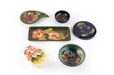 Lot 690 - Moorcroft Eight pieces with various patterns...