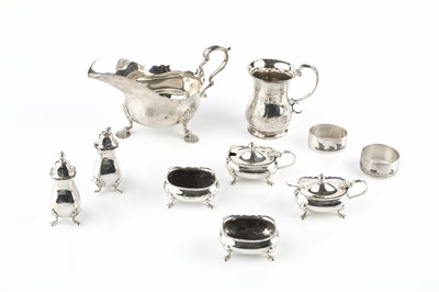 Lot 615 - A silver sauce boat, with scroll handle and...