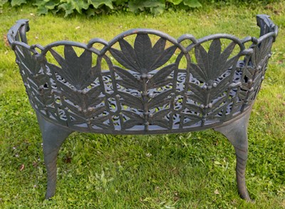 Lot 699 - A pair of green painted cast iron garden...