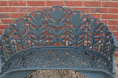 Lot 699 - A pair of green painted cast iron garden...