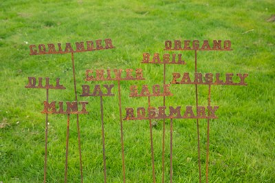 Lot 824 - A set of ten steel herb labels on posts, the...