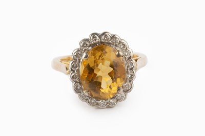 Lot 38 - A citrine and diamond cluster ring, the oval...