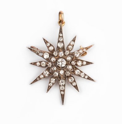 Lot 165 - A diamond star brooch/pendant, highlighted...