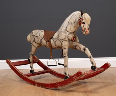 Lot 149 - An old small size wood and cloth rocking horse...