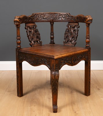 Lot 280 - A 19th century carved oak corner chair with...