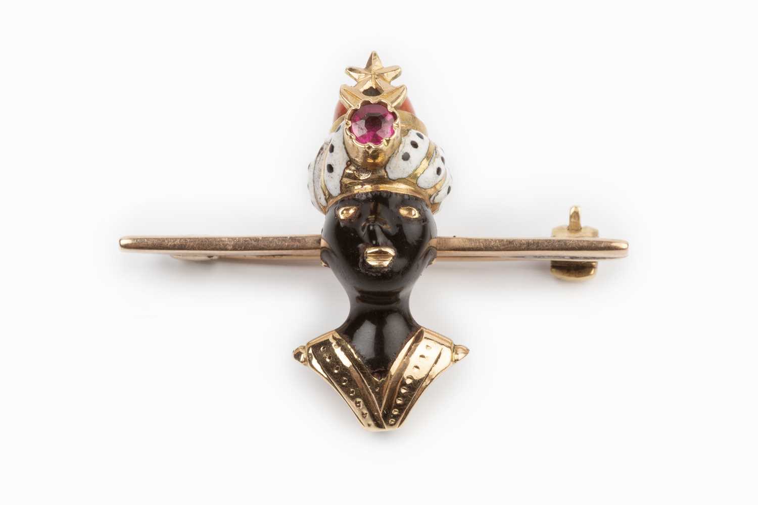 Lot 25 - An enamel and gem set blackamoor bar brooch,...