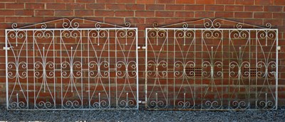 Lot 703 - A pair of white painted wrought iron scroll...