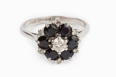 Lot 103 - A sapphire and diamond cluster ring, the...