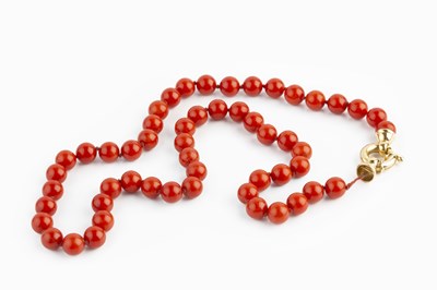 Lot 136 - A coral bead necklace, comprising a single...