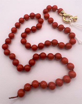 Lot 136 - A coral bead necklace, comprising a single...