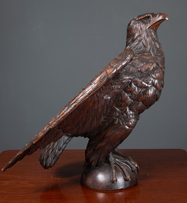 Lot 154 - An antique carved oak dark stained eagle 61cm...