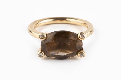 Lot 55 - A smoky quartz and diamond dress ring, the...