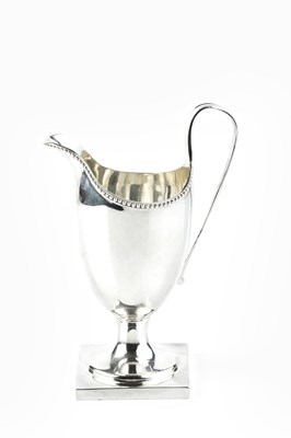 Lot 338 - A silver cream jug, with beaded border, strap...