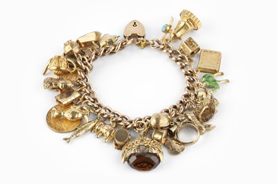 Lot 78 - A charm bracelet, the curb-link bracelet with...