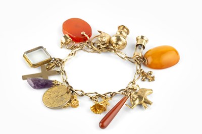 Lot 6 - A charm bracelet, the yellow precious metal...