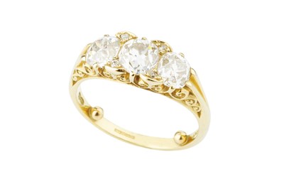 Lot 120 - A diamond three stone ring, the principal...