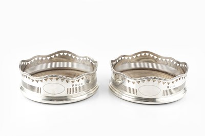 Lot 585 - A pair of silver bottle coasters, of shaped...