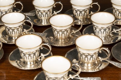 Lot 378 - A set of twelve white metal and porcelain...