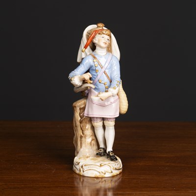 Lot 387 - A Meissen figurine of a water seller wearing a...