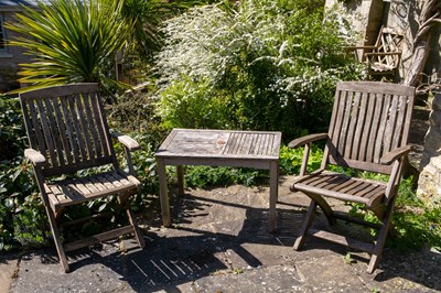 Lot 742 - Two teak folding chairs and a small table the...