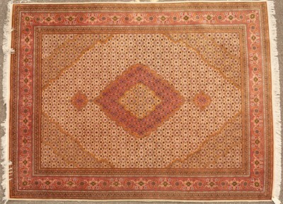 Lot 265 - An Oriental pink ground rug with central...