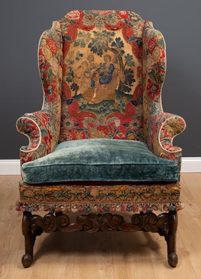 Lot 283 - A James II walnut wing armchair with an eared...