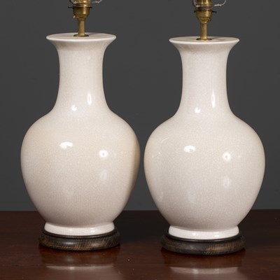 Lot 209 - A pair of cream crackle glaze ceramic table...