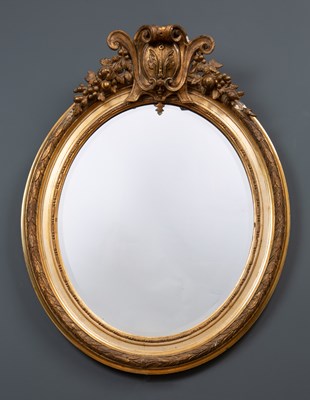 Lot 64 - A decorative gilt oval wall mirror with...