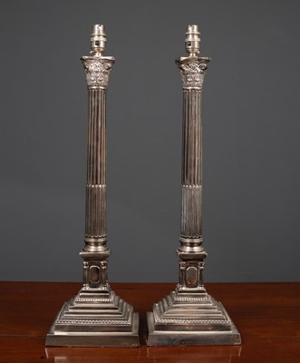 Lot 66 - A pair of silvered table lamps in the form of...