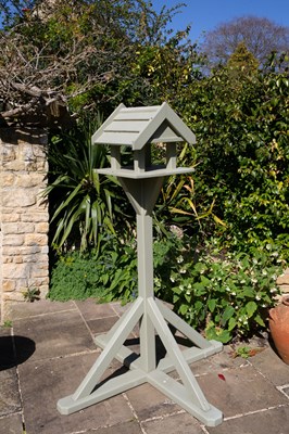 Lot 776 - A green painted wooden bird table on a...