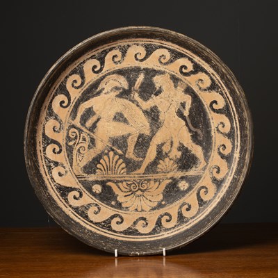 Lot 162 - A terracotta dish with classical ornament in...