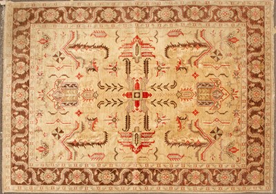 Lot 80 - An Oriental dark cream ground small carpet...