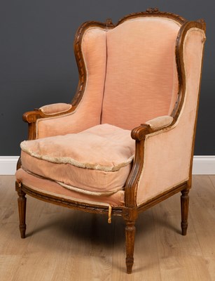 Lot 108 - A French carved beechwood framed wing back...