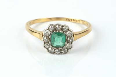 Lot 154 - An emerald and diamond cluster ring, the...