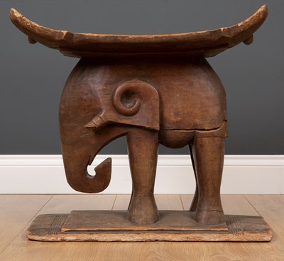 Lot 296 - An African carved wooden African tribal stool...