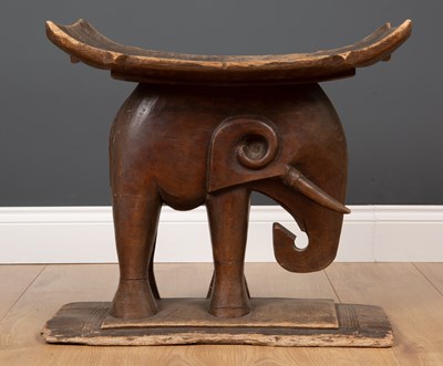 Lot 296 - An African carved wooden African tribal stool...