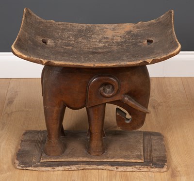 Lot 296 - An African carved wooden African tribal stool...