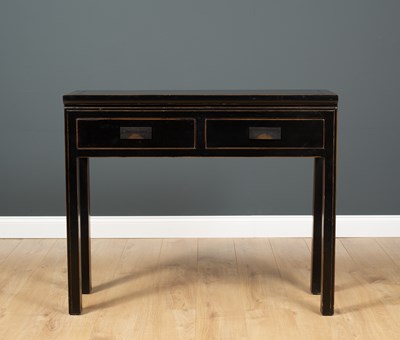 Lot 518 - An Oriental black lacquered side table with...