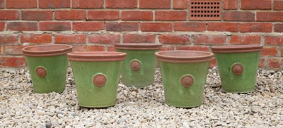 Lot 840 - A set of five green glazed terracotta circular...