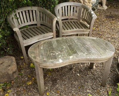 Lot 846 - A pair of teak horseshoe shaped garden chairs...