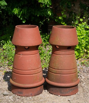 Lot 855 - A pair of terracotta chimney pots with conical...