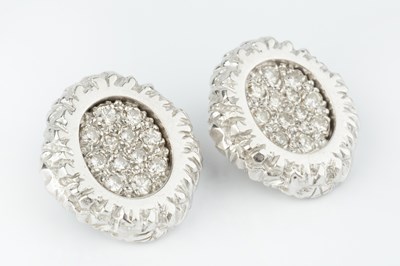 Lot 232 - A pair of diamond set ear clips, each shaped...