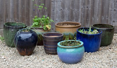 Lot 877 - A pair of green glazed ribbed circular garden...